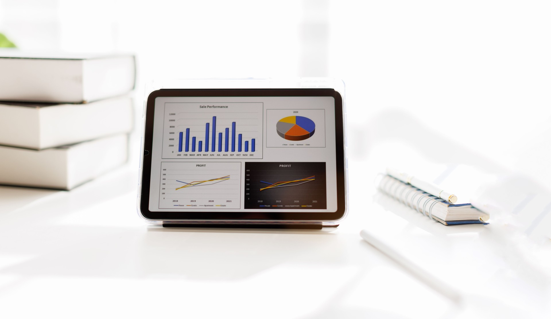 Business analyzing financial statistics displayed on the tablet screen on desk