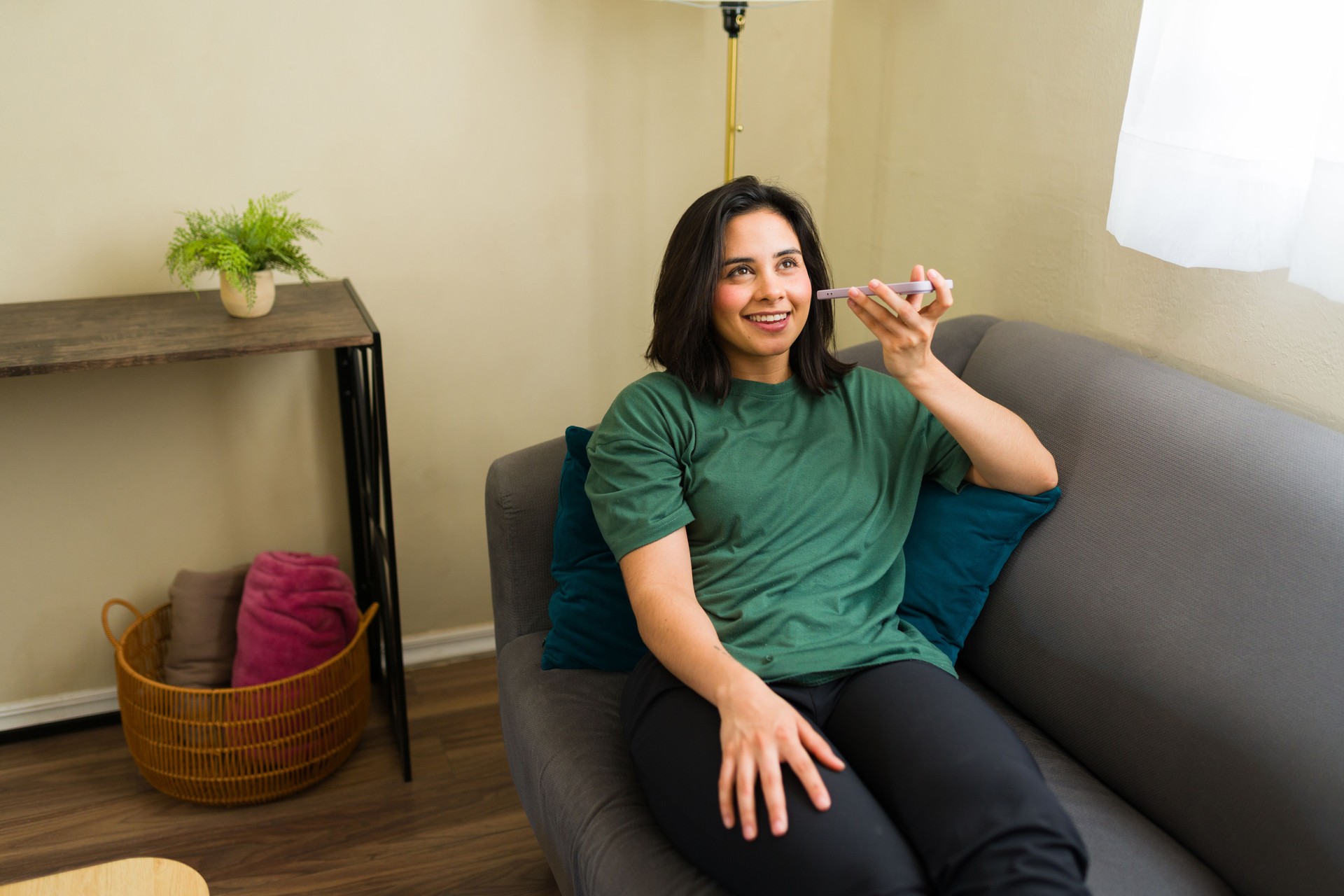 Freelancer working from home using smartphone voice assistant